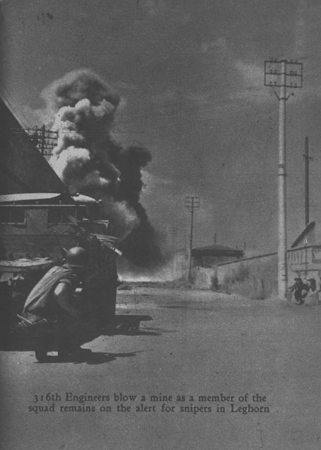 [316th Engineers blow a mine as a member of the squad remains on the alert for snipers in Leghorn]