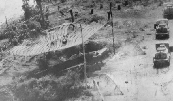 Japanese Nakajima Ki-43 Oscar parked under a camouflage net. Japanese Nakajima Ki-43 Oscar parked under a camouflage net.